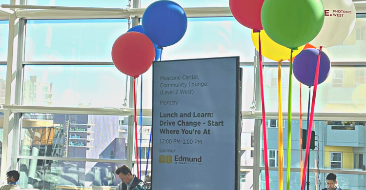 Electronic sign at Photonics West, surrounded by colorful balloons
